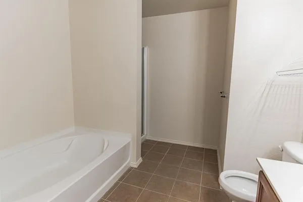 a white bath tub sitting next to a toilet