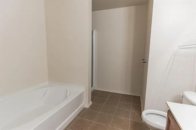 a white bath tub sitting next to a toilet