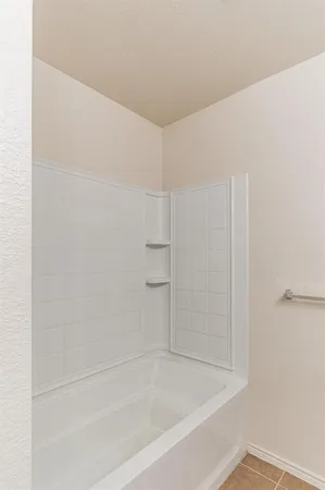 a bathroom with a tub a sink and a mirror