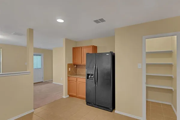 a kitchen with stainless steel appliances a refrigerator and a stove top oven