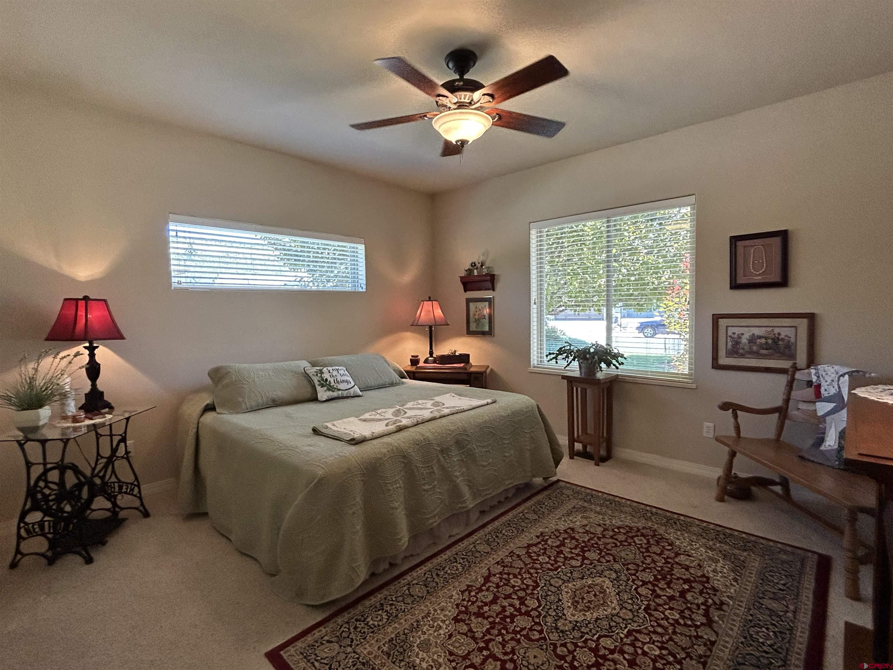 850 Southeast Pinyon Street Cedaredge, CO 81413 - Photo 23 of 45 a bedroom with a bed and window