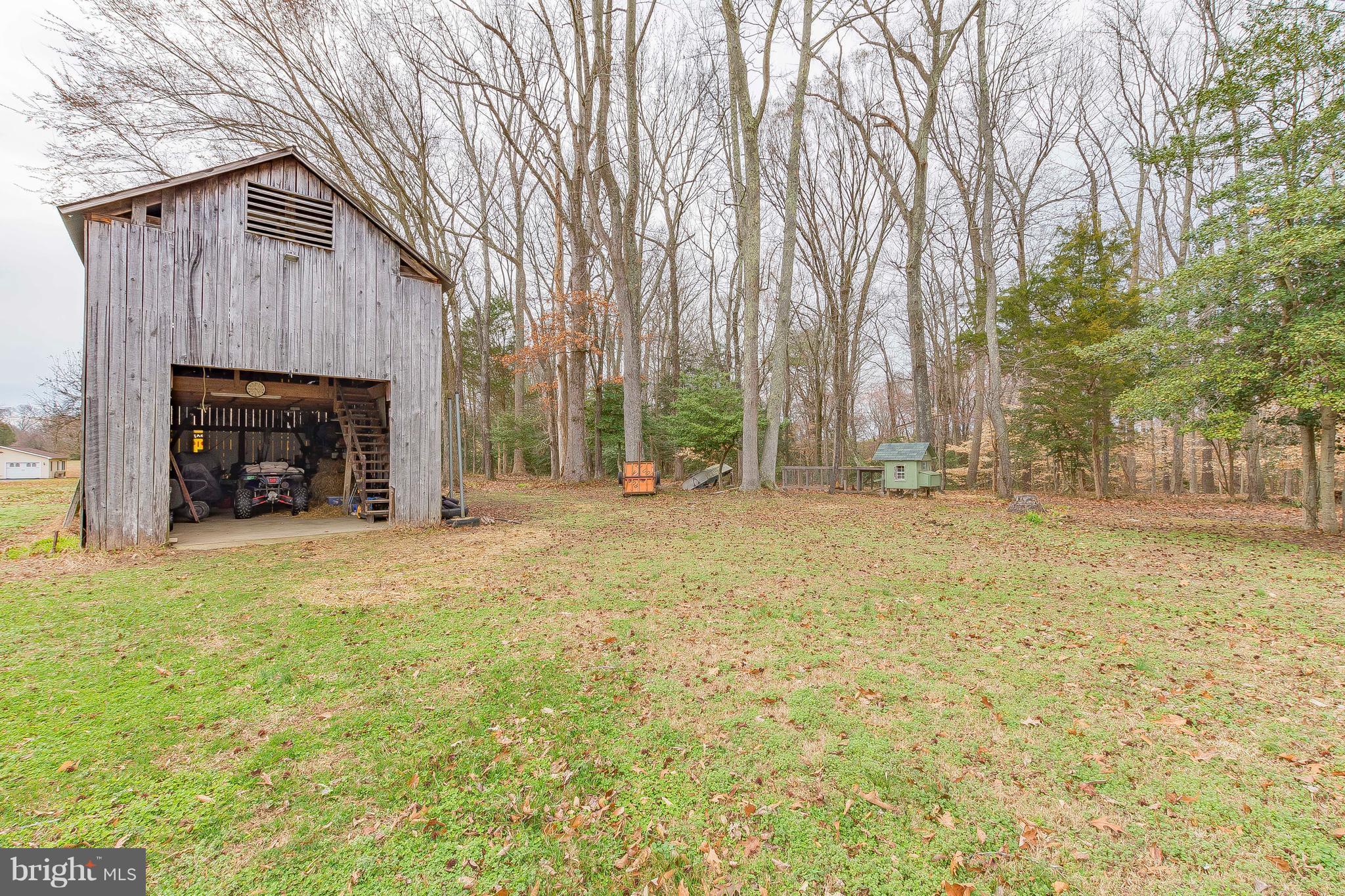3181 Carroll Road Huntingtown, MD 20639 - Photo 2 of 28 a house with trees in front of it