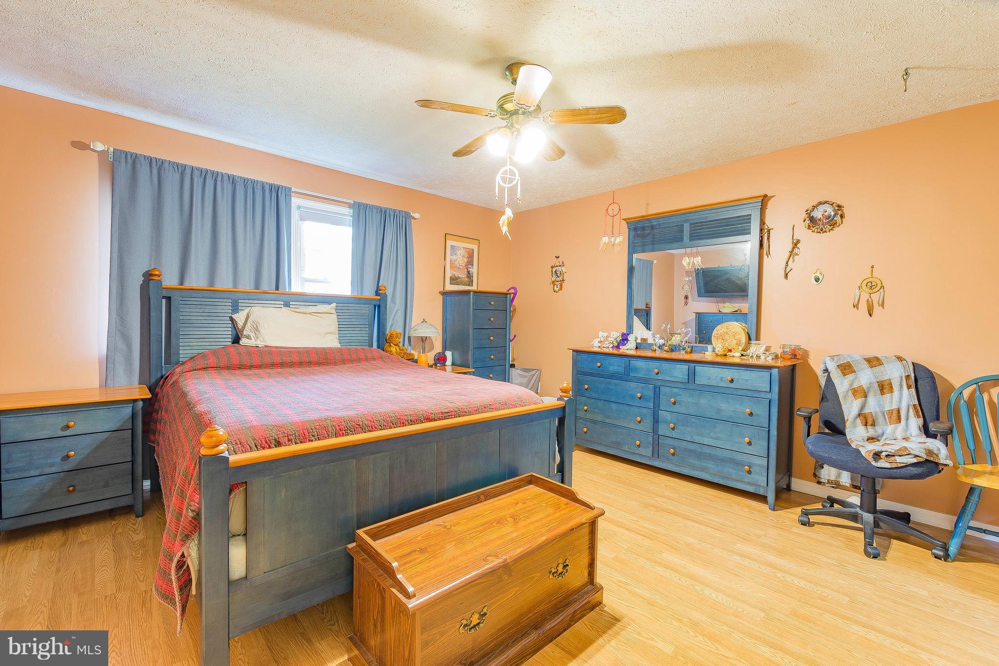 3181 Carroll Road Huntingtown, MD 20639 - Photo 14 of 28 a bed room with a bed and dresser