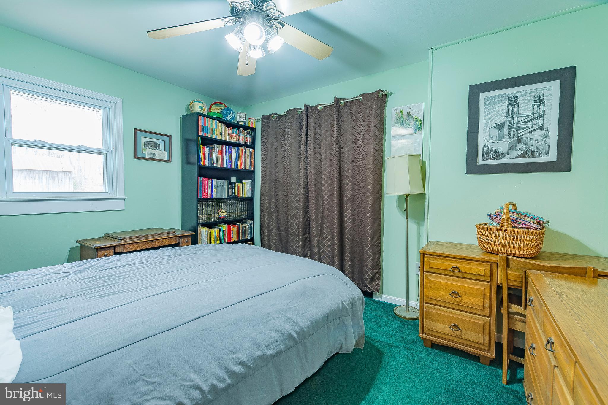 3181 Carroll Road Huntingtown, MD 20639 - Photo 15 of 28 a bedroom with a bed and a bookshelf