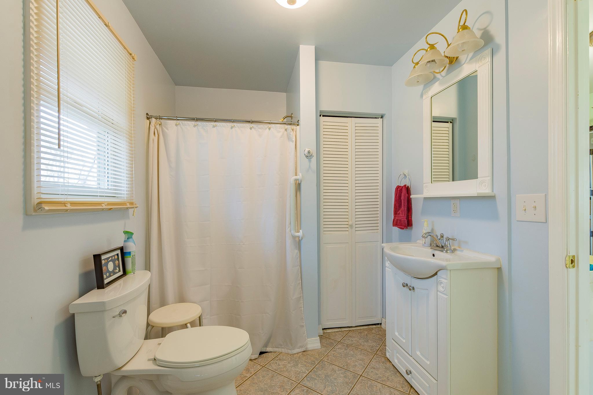 3181 Carroll Road Huntingtown, MD 20639 - Photo 16 of 28 a bathroom with a sink toilet and mirror