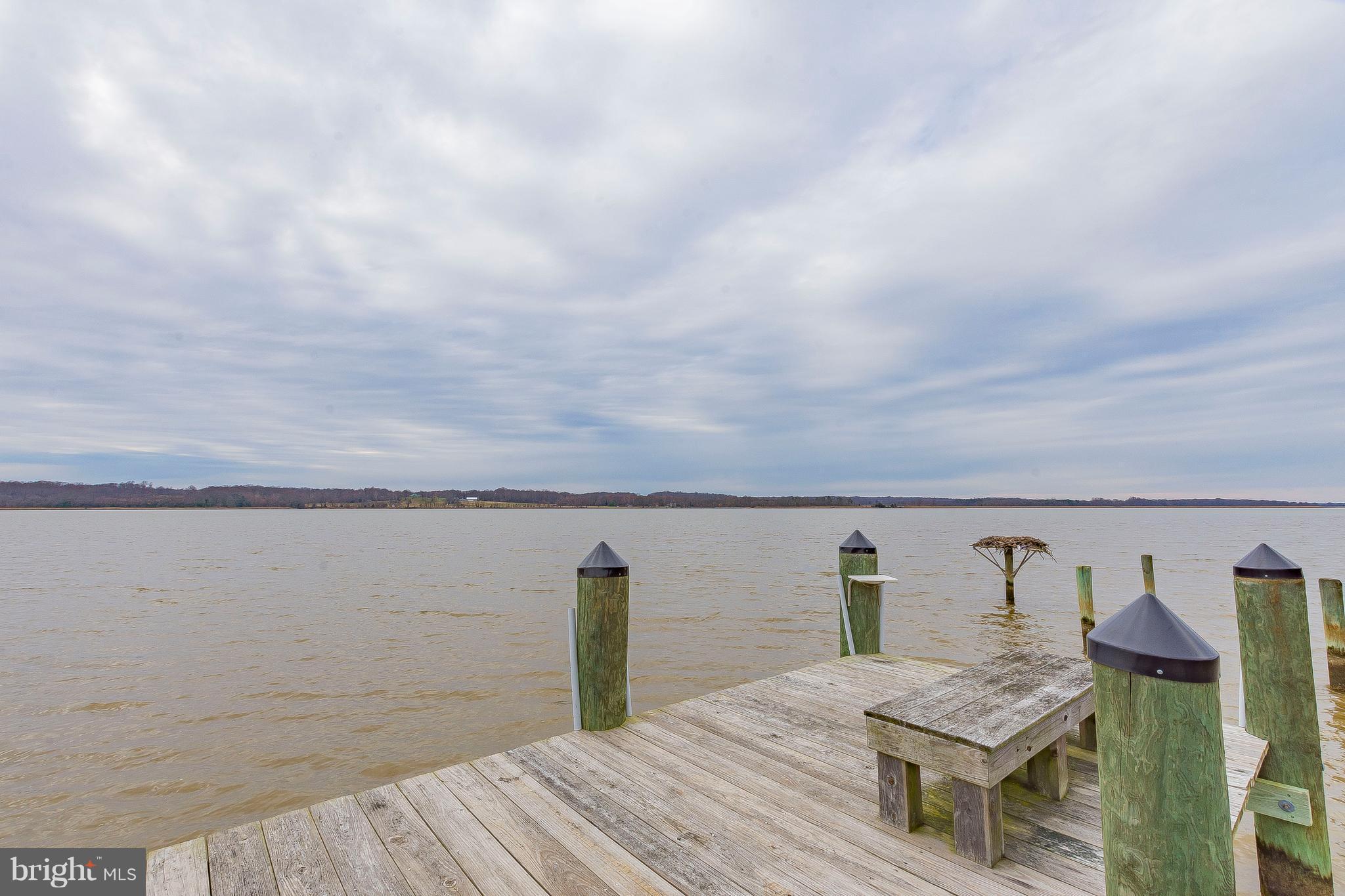 3181 Carroll Road Huntingtown, MD 20639 - Photo 23 of 28 a view of roof deck with two chairs and wooden floor