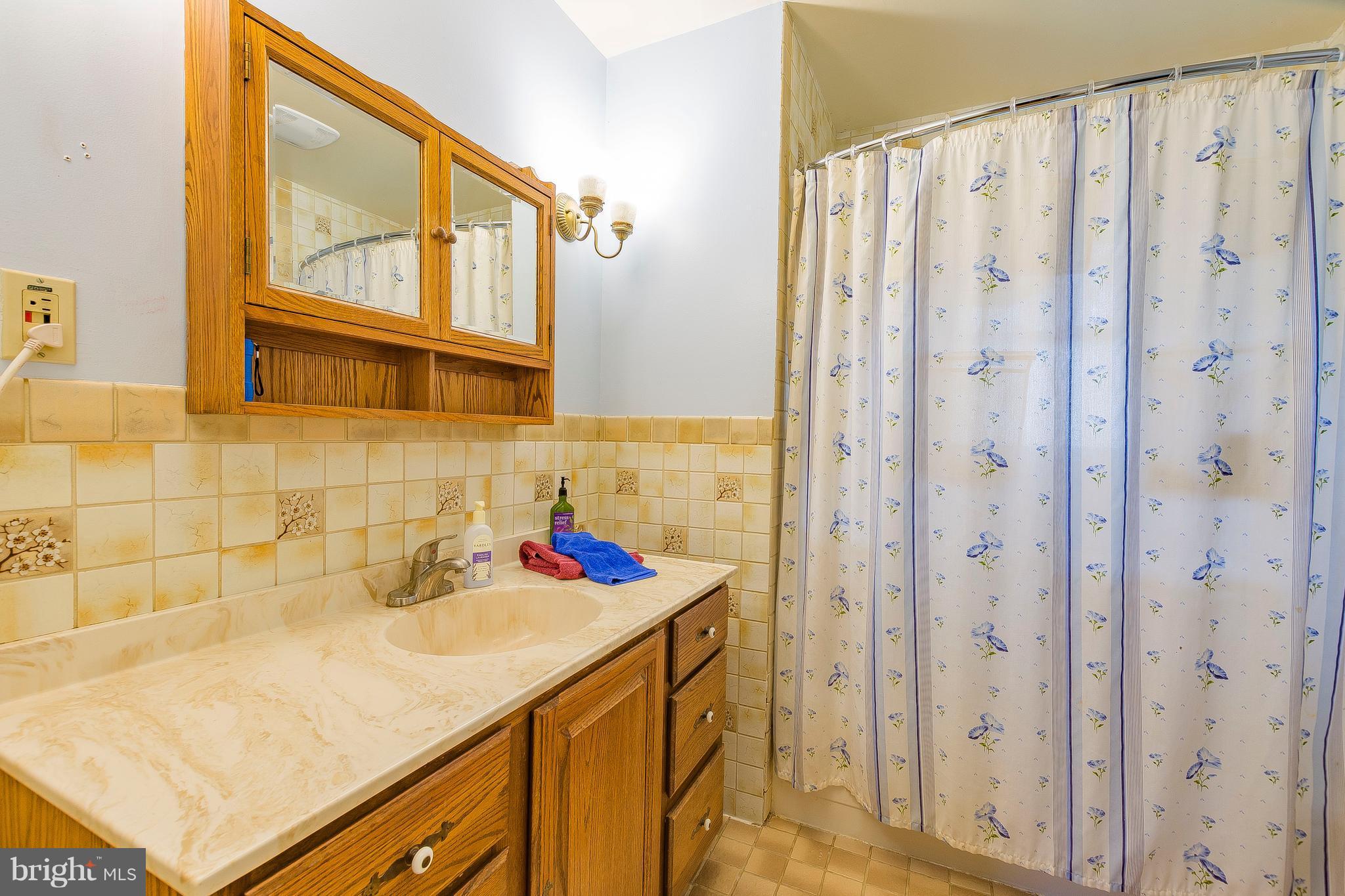 3181 Carroll Road Huntingtown, MD 20639 - Photo 26 of 28 a bathroom with a sink and a mirror