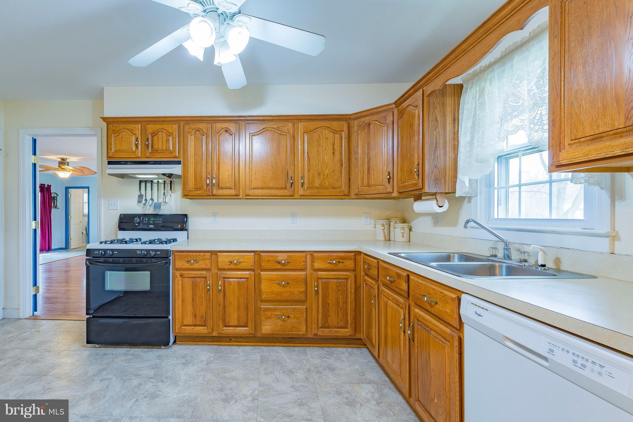 3181 Carroll Road Huntingtown, MD 20639 - Photo 6 of 28 a kitchen with stainless steel appliances granite countertop a sink dishwasher stove and cabinets