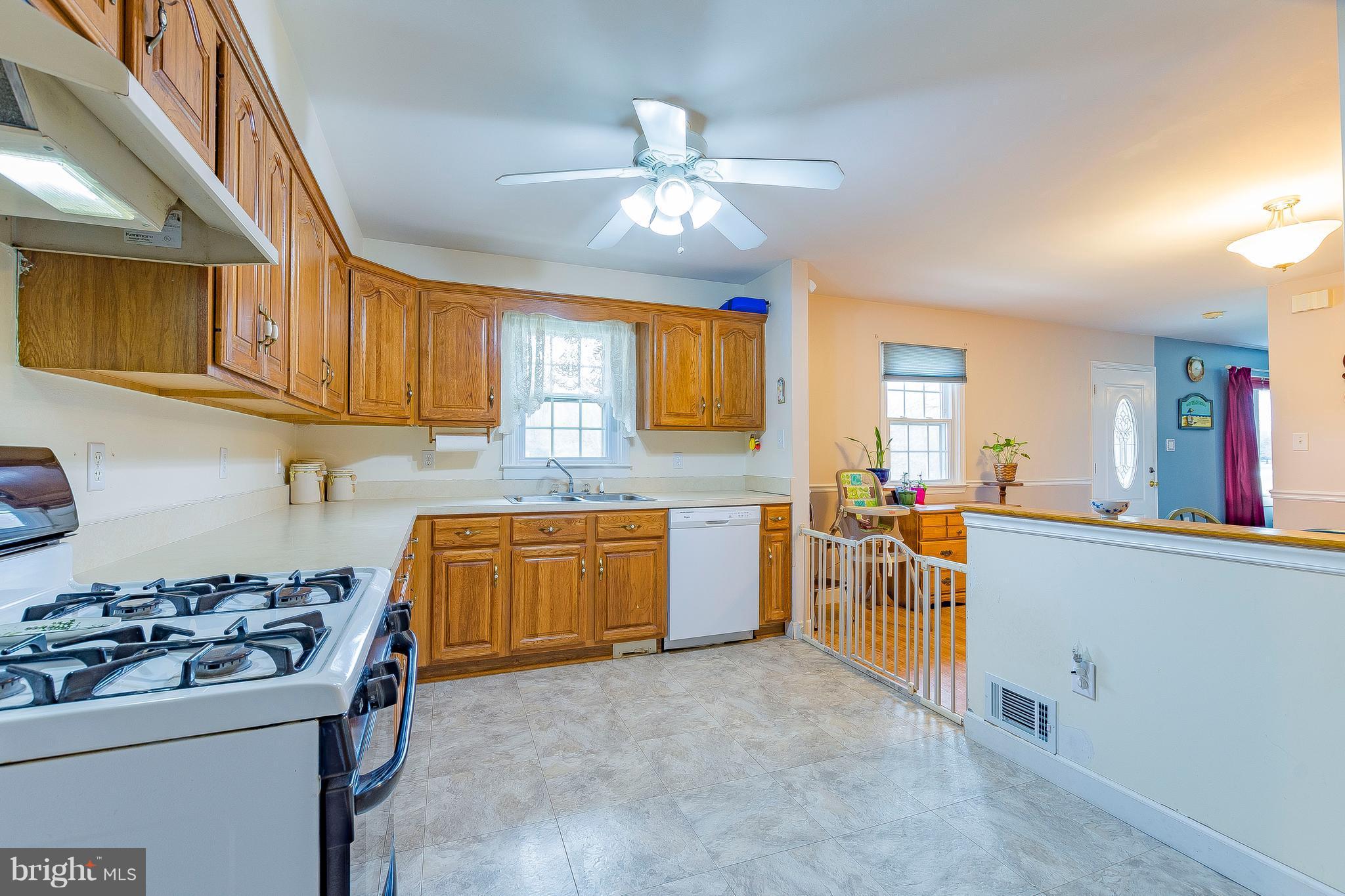 3181 Carroll Road Huntingtown, MD 20639 - Photo 7 of 28 a kitchen with a sink stove and cabinets
