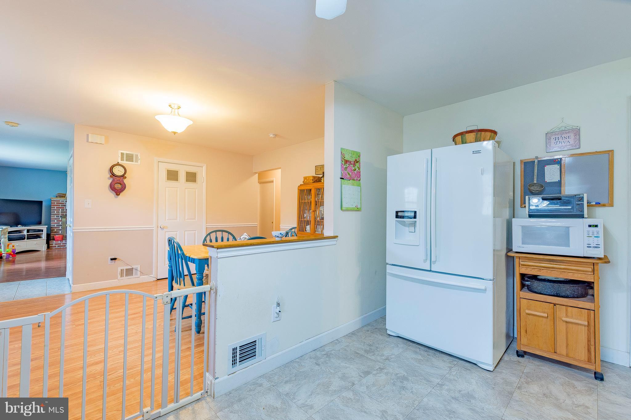 3181 Carroll Road Huntingtown, MD 20639 - Photo 8 of 28 a white refrigerator freezer and a stove sitting inside of a kitchen