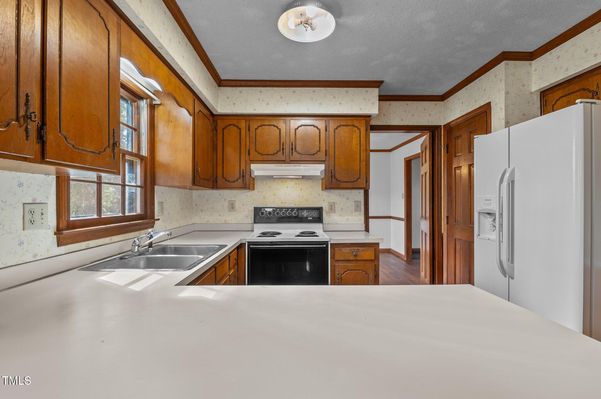 8404 Sleepy Creek Drive Raleigh, NC 27613 - Photo 10 of 39 a kitchen with stainless steel appliances granite countertop a refrigerator and a sink