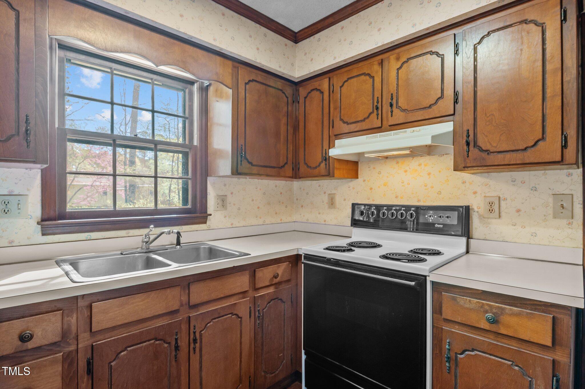 8404 Sleepy Creek Drive Raleigh, NC 27613 - Photo 11 of 39 a kitchen with stainless steel appliances granite countertop a sink stove and cabinets