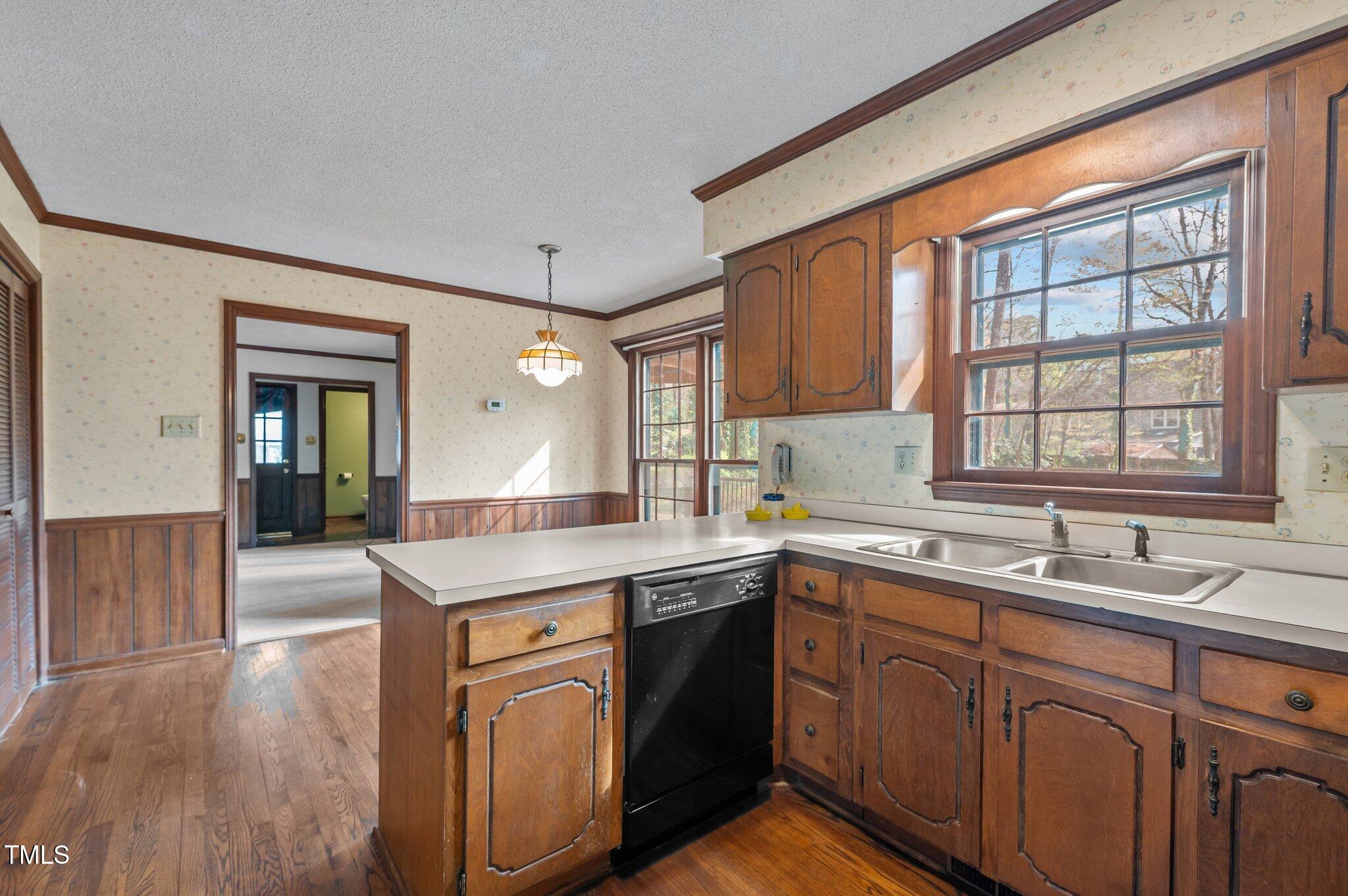 8404 Sleepy Creek Drive Raleigh, NC 27613 - Photo 12 of 39 a kitchen with a sink stove and cabinets