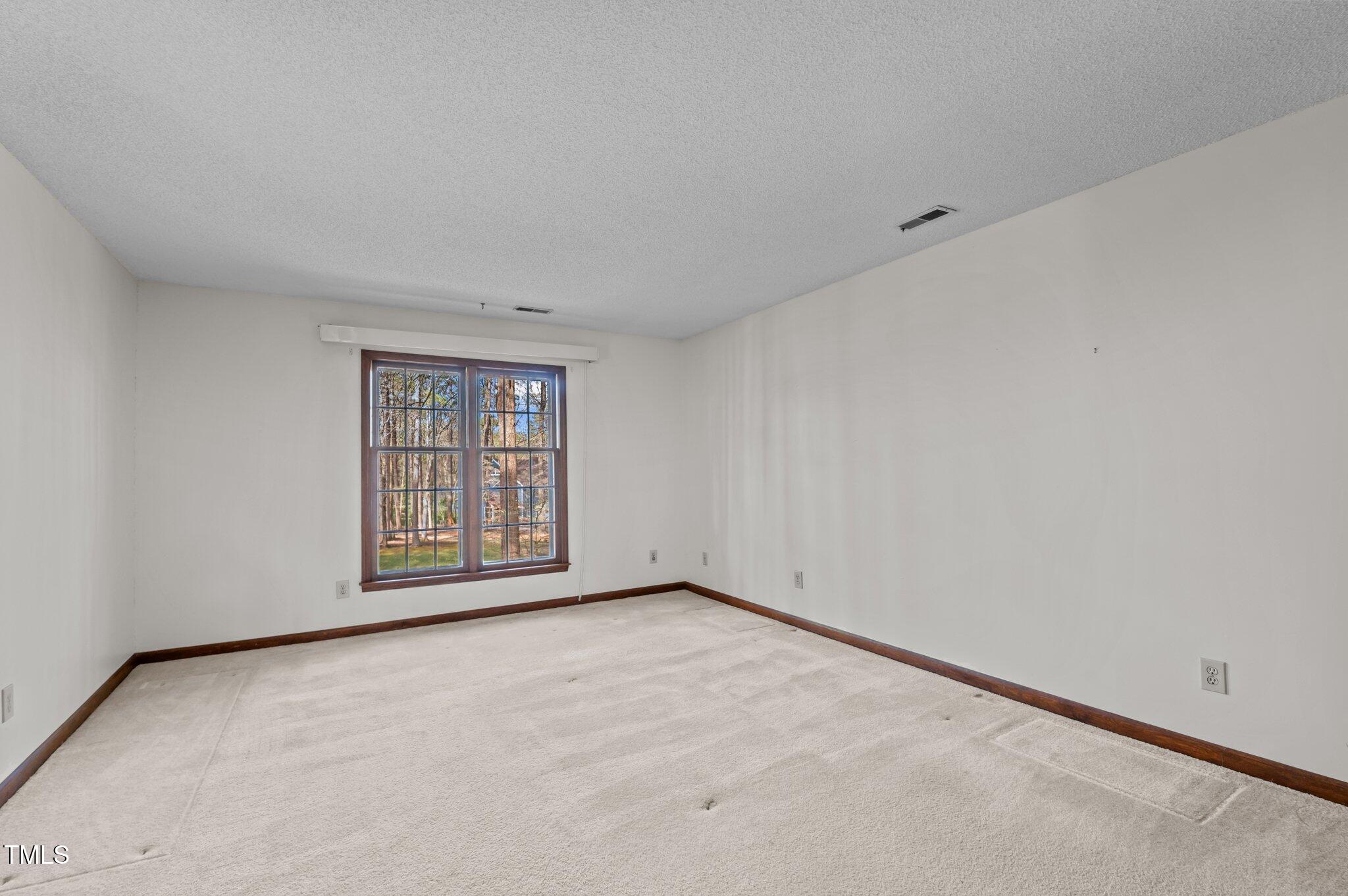 8404 Sleepy Creek Drive Raleigh, NC 27613 - Photo 20 of 39 a view of an empty room with a window