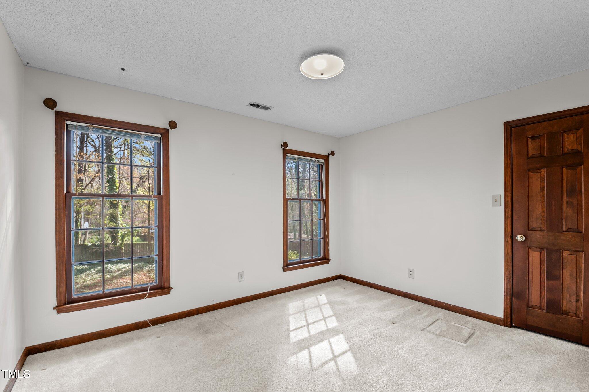8404 Sleepy Creek Drive Raleigh, NC 27613 - Photo 21 of 39 a view of an empty room with windows
