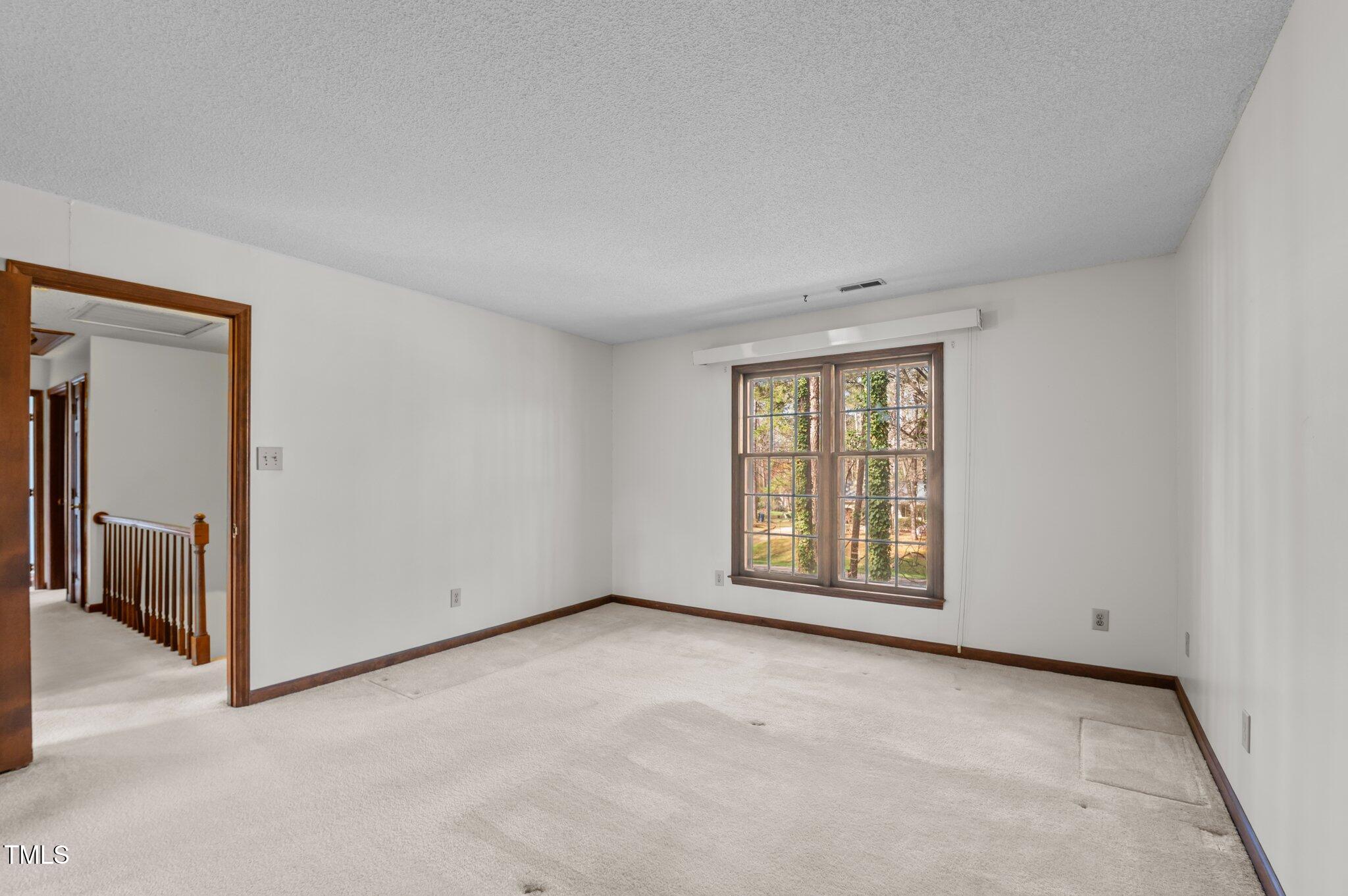 8404 Sleepy Creek Drive Raleigh, NC 27613 - Photo 23 of 39 an empty room with windows and closet