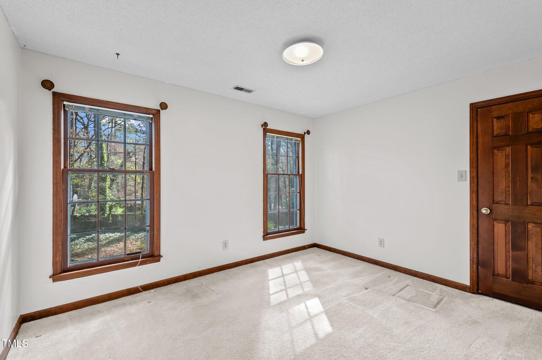 8404 Sleepy Creek Drive Raleigh, NC 27613 - Photo 24 of 39 a view of an empty room with window and closet area