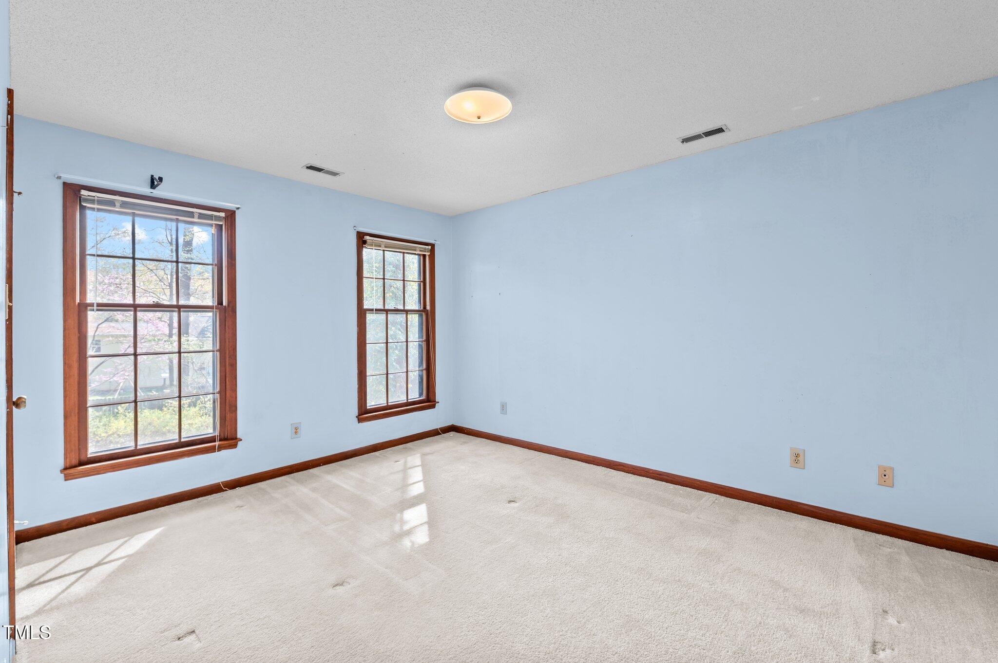 8404 Sleepy Creek Drive Raleigh, NC 27613 - Photo 28 of 39 an empty room with windows