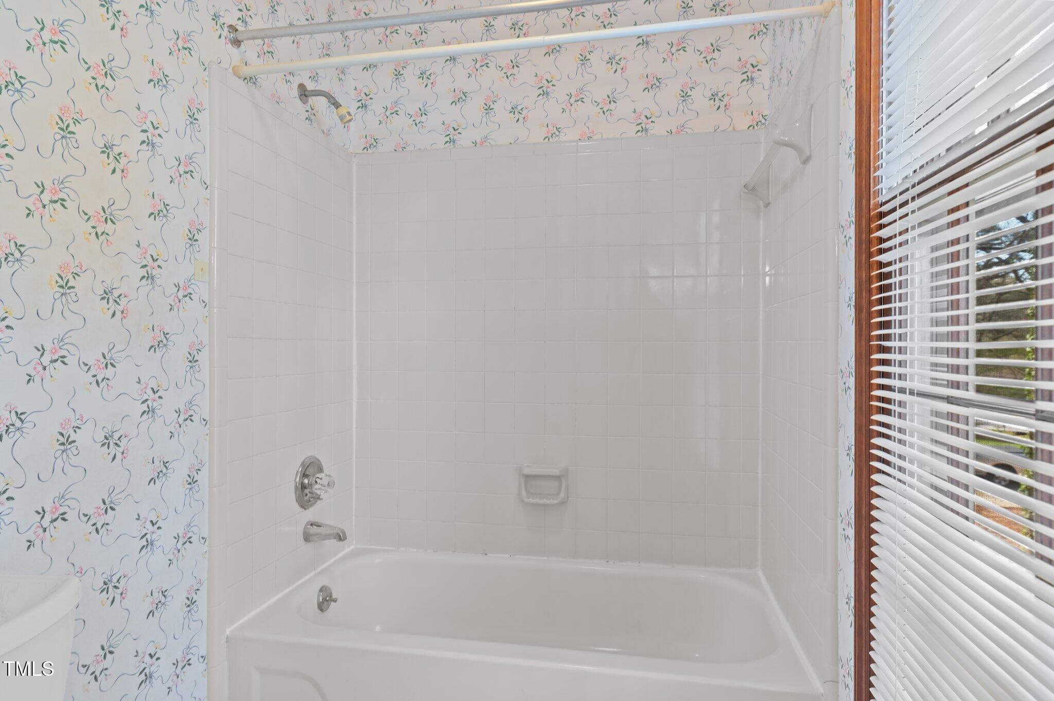8404 Sleepy Creek Drive Raleigh, NC 27613 - Photo 29 of 39 a bathroom with a bathtub