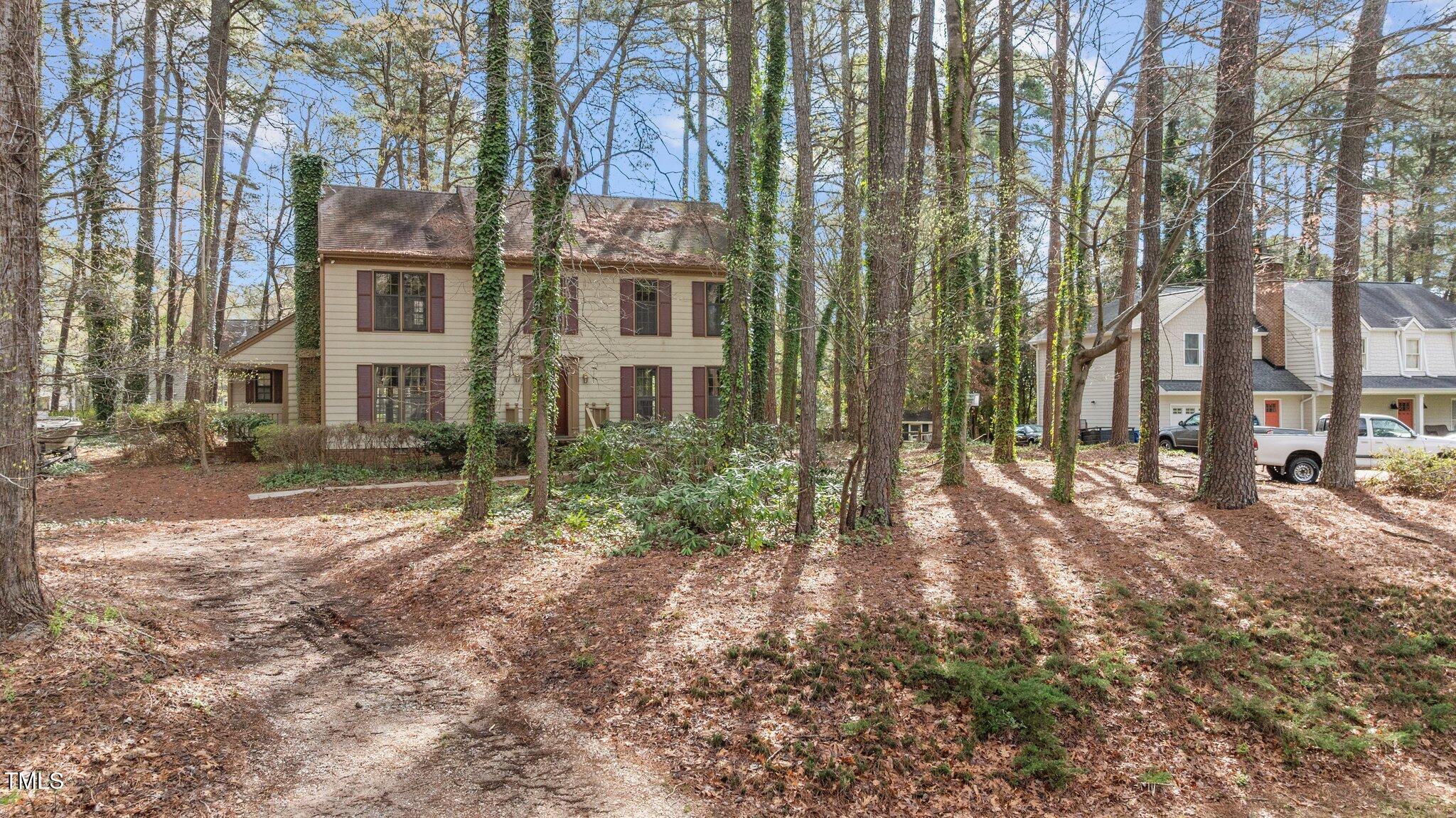 8404 Sleepy Creek Drive Raleigh, NC 27613 - Photo 2 of 39 a view of a large building with trees in the background
