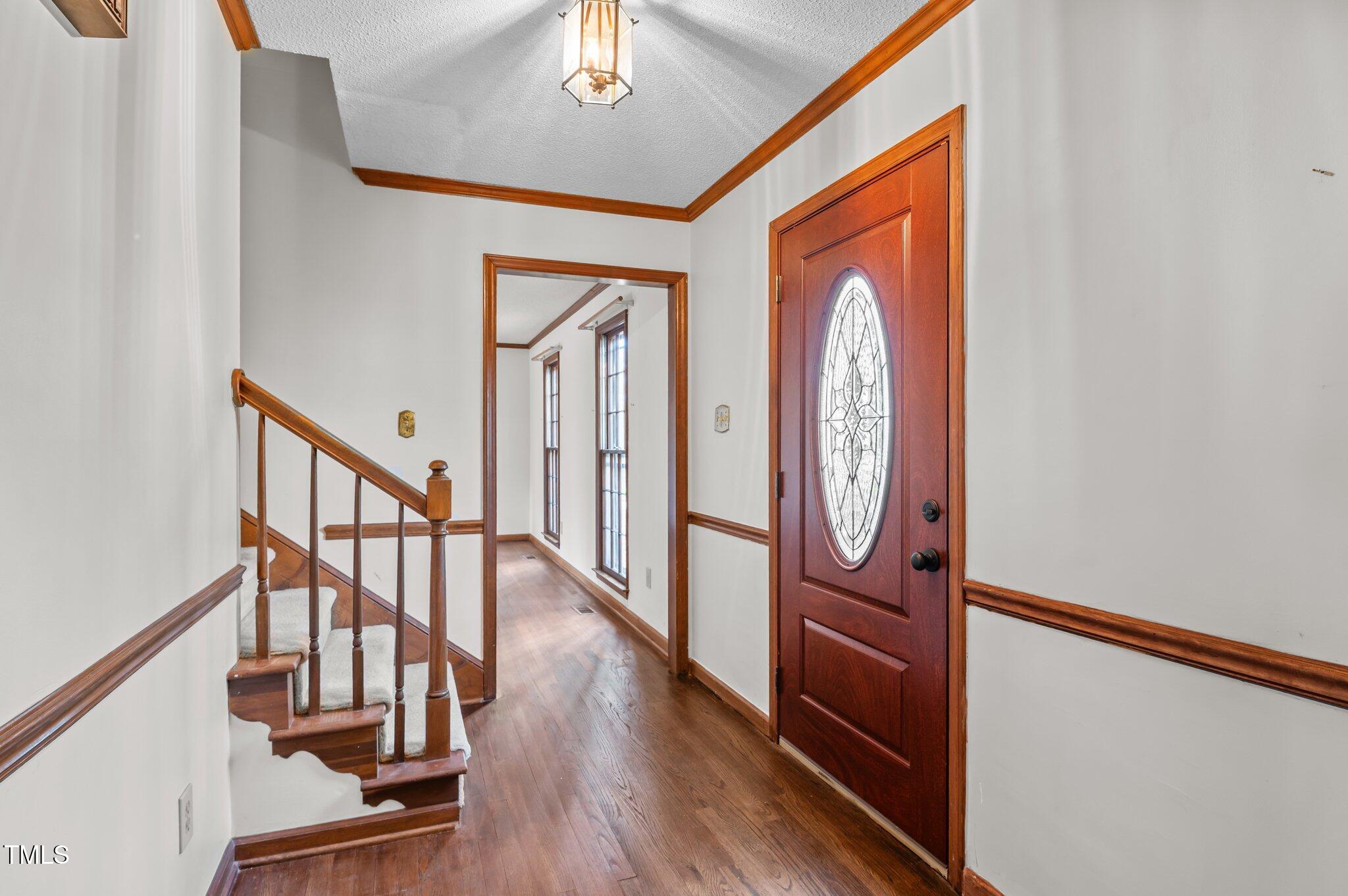 8404 Sleepy Creek Drive Raleigh, NC 27613 - Photo 3 of 39 a view of front door with wooden floor and stairs