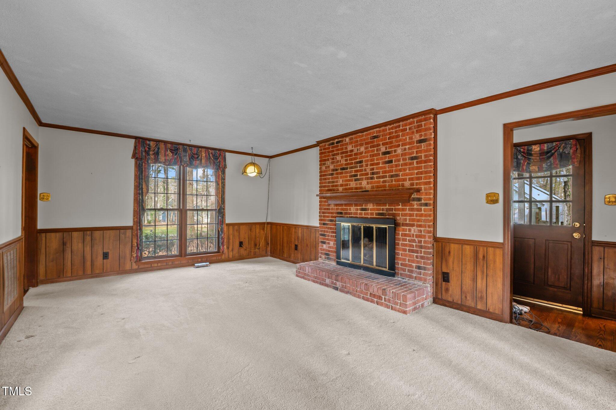 8404 Sleepy Creek Drive Raleigh, NC 27613 - Photo 6 of 39 an empty room with furniture and fireplace