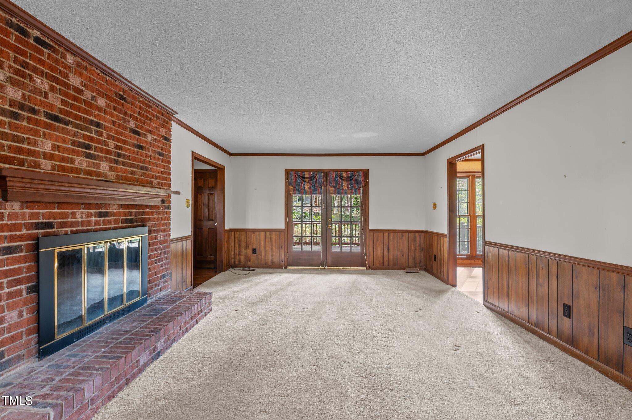 8404 Sleepy Creek Drive Raleigh, NC 27613 - Photo 7 of 39 a view of an empty room with a fireplace and a window