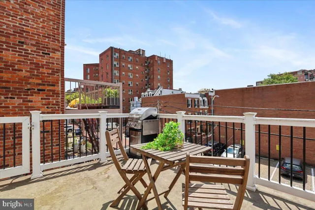 a kitchen with stainless steel appliances granite countertop wooden floor dining table and chairs