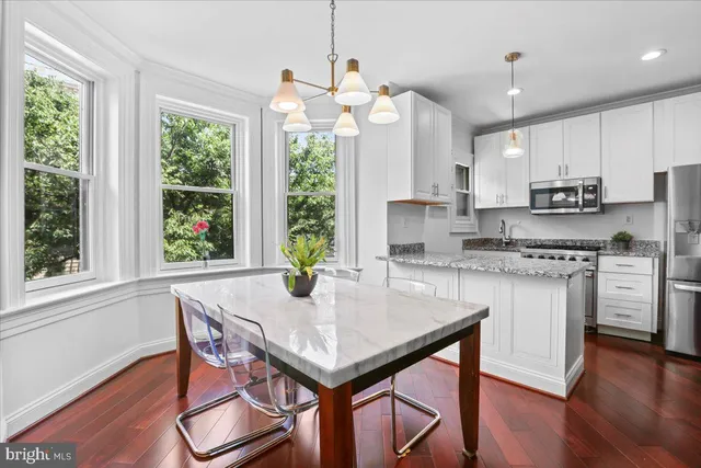 a kitchen with a sink window and cabinets