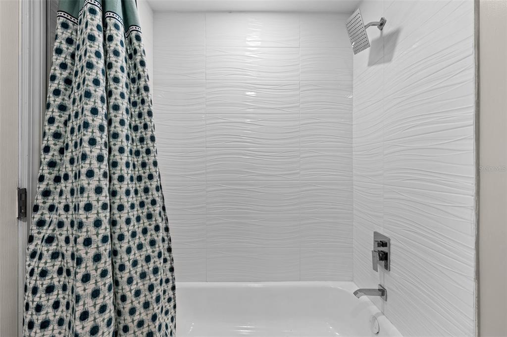 2506 Bay Boulevard Indian Rocks Beach, FL 33785 - Photo 11 of 36 a bathroom with a bathtub and shower