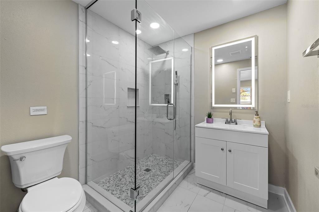 2506 Bay Boulevard Indian Rocks Beach, FL 33785 - Photo 15 of 36 a bathroom with a shower a toilet and sink