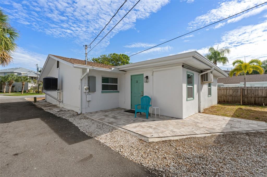 2506 Bay Boulevard Indian Rocks Beach, FL 33785 - Photo 17 of 36 a view of a white house with a yard and potted plants