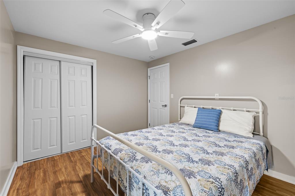 2506 Bay Boulevard Indian Rocks Beach, FL 33785 - Photo 23 of 36 a bedroom with a large bed and a chandelier