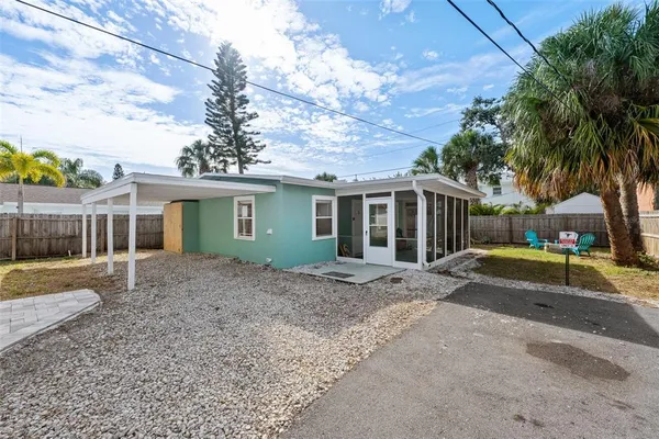 a view of a yard with a house and a tree