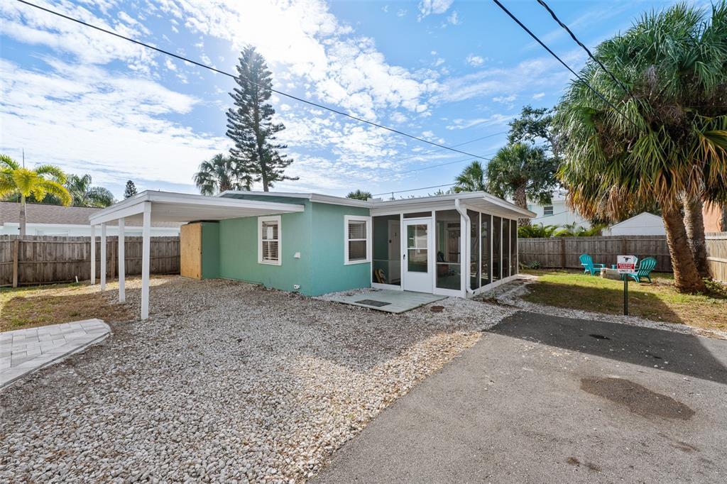 2506 Bay Boulevard Indian Rocks Beach, FL 33785 - Photo 24 of 36 a view of a yard with a house and a tree