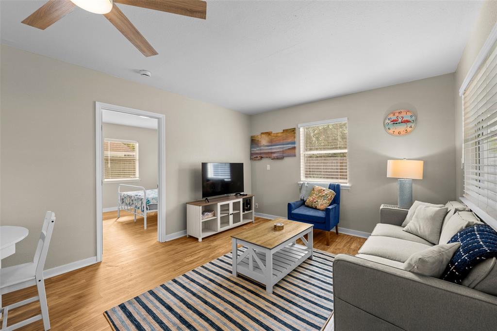 2506 Bay Boulevard Indian Rocks Beach, FL 33785 - Photo 26 of 36 a living room with furniture and a flat screen tv