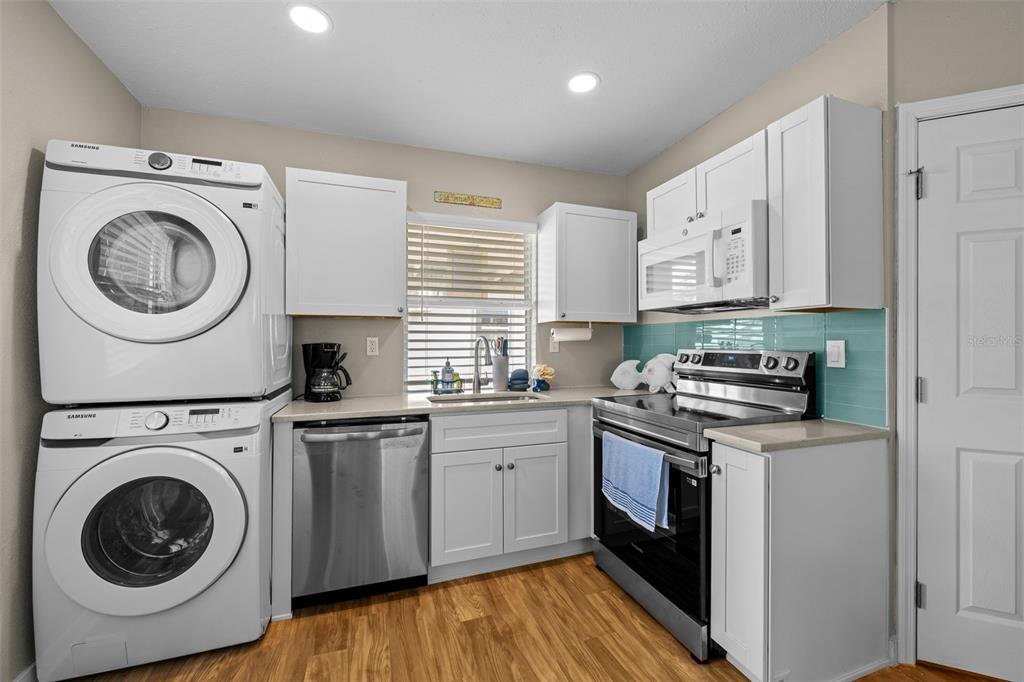 2506 Bay Boulevard Indian Rocks Beach, FL 33785 - Photo 28 of 36 a kitchen with a stove top oven sink and cabinets