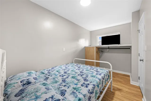 a bedroom with a bed and a flat screen tv