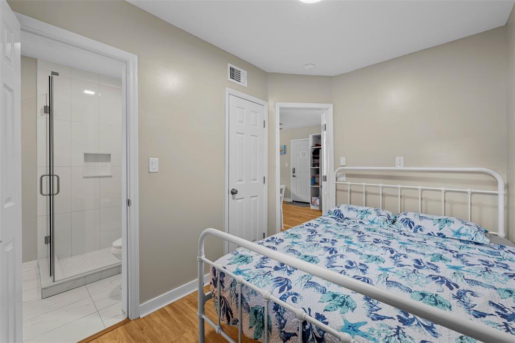 2506 Bay Boulevard Indian Rocks Beach, FL 33785 - Photo 30 of 36 a bedroom with a bed and a dresser