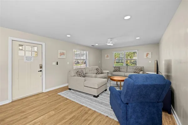 a living room with furniture and a wooden floor