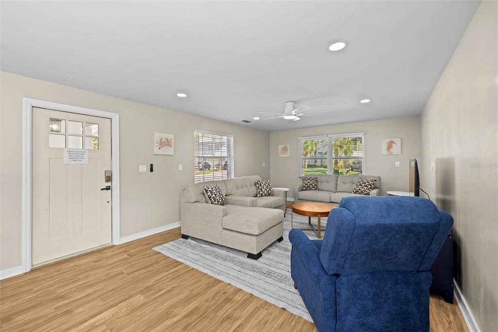 2506 Bay Boulevard Indian Rocks Beach, FL 33785 - Photo 3 of 36 a living room with furniture and a wooden floor