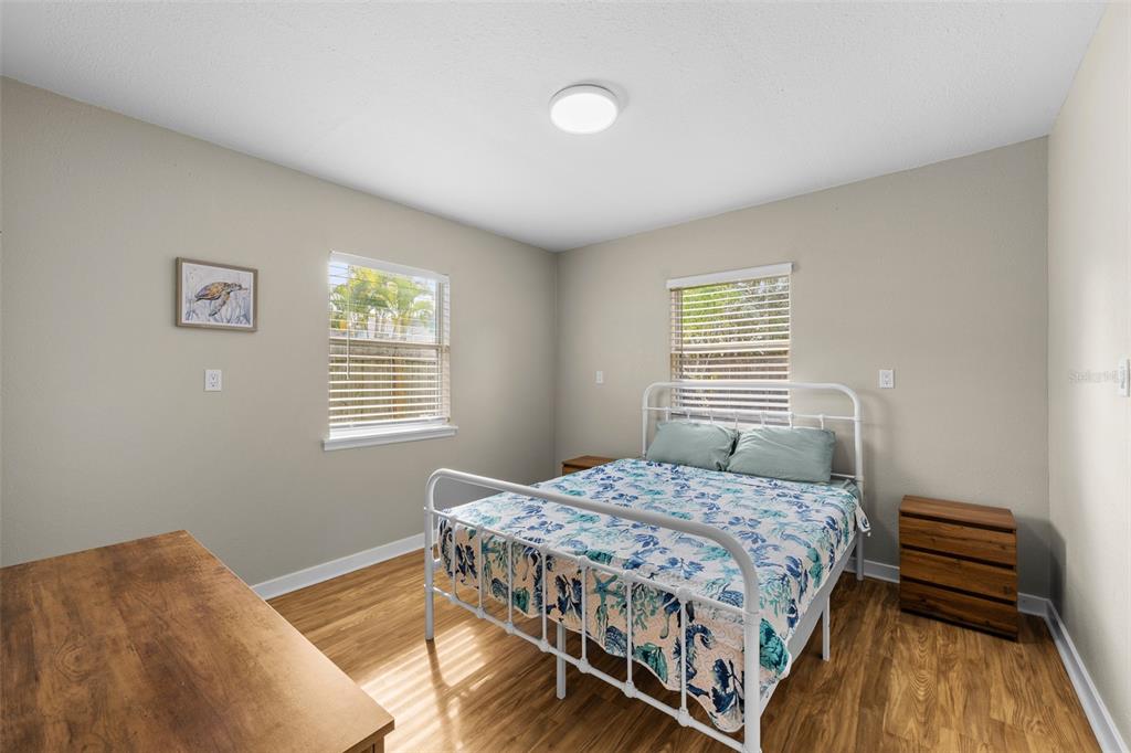 2506 Bay Boulevard Indian Rocks Beach, FL 33785 - Photo 33 of 36 a bedroom with a bed and wooden floor