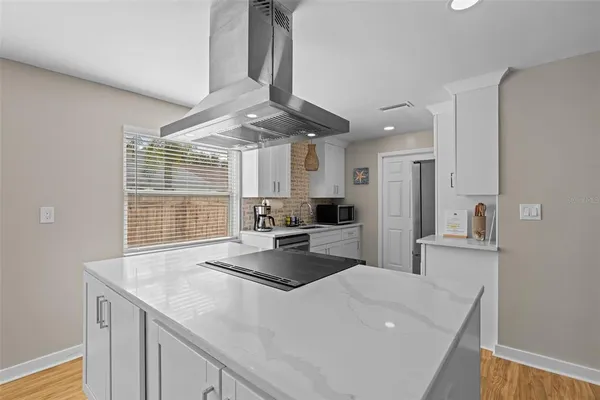 a kitchen with stainless steel appliances a sink stove and cabinets