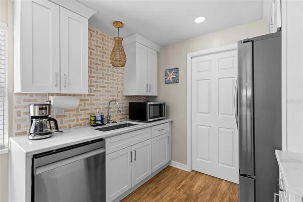 a kitchen with a sink cabinets and stainless steel appliances