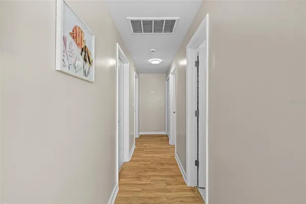a view of a hallway with wooden floor