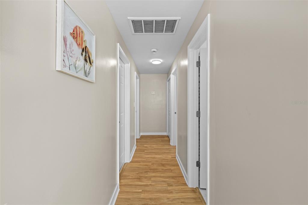 2506 Bay Boulevard Indian Rocks Beach, FL 33785 - Photo 9 of 36 a view of a hallway with wooden floor