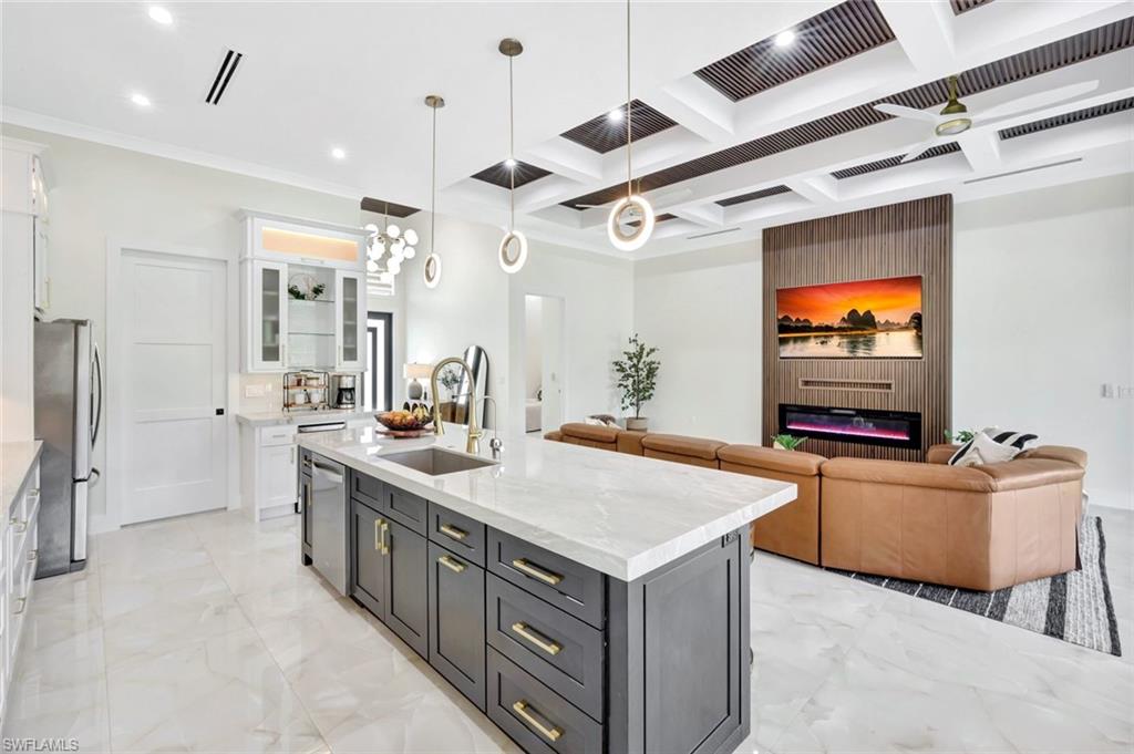 2546 4th Street Northwest Naples, FL 34120 - Photo 11 of 44 a kitchen with stainless steel appliances granite countertop a sink and a refrigerator