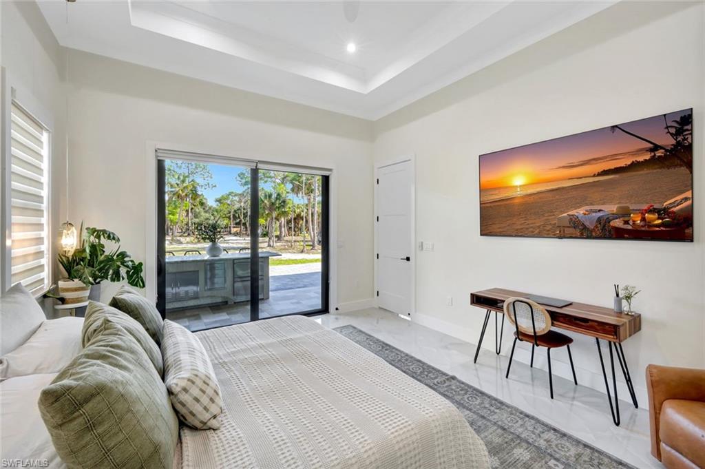 2546 4th Street Northwest Naples, FL 34120 - Photo 15 of 44 a bedroom with a bed and a flat screen tv