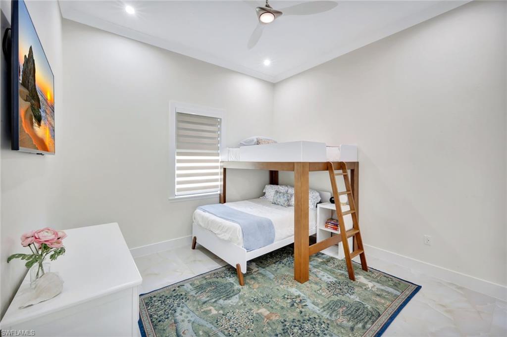 2546 4th Street Northwest Naples, FL 34120 - Photo 21 of 44 Bedroom featuring marble finish floors, a ceiling fan, and recessed lighting