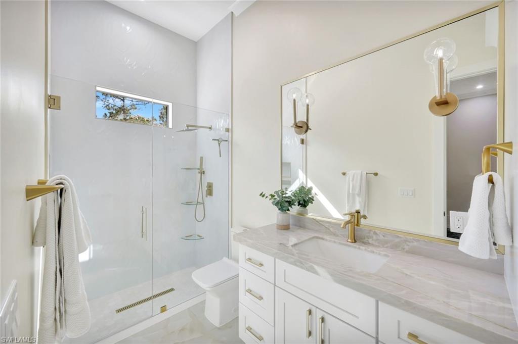 2546 4th Street Northwest Naples, FL 34120 - Photo 22 of 44 a bathroom with a granite countertop sink toilet and shower